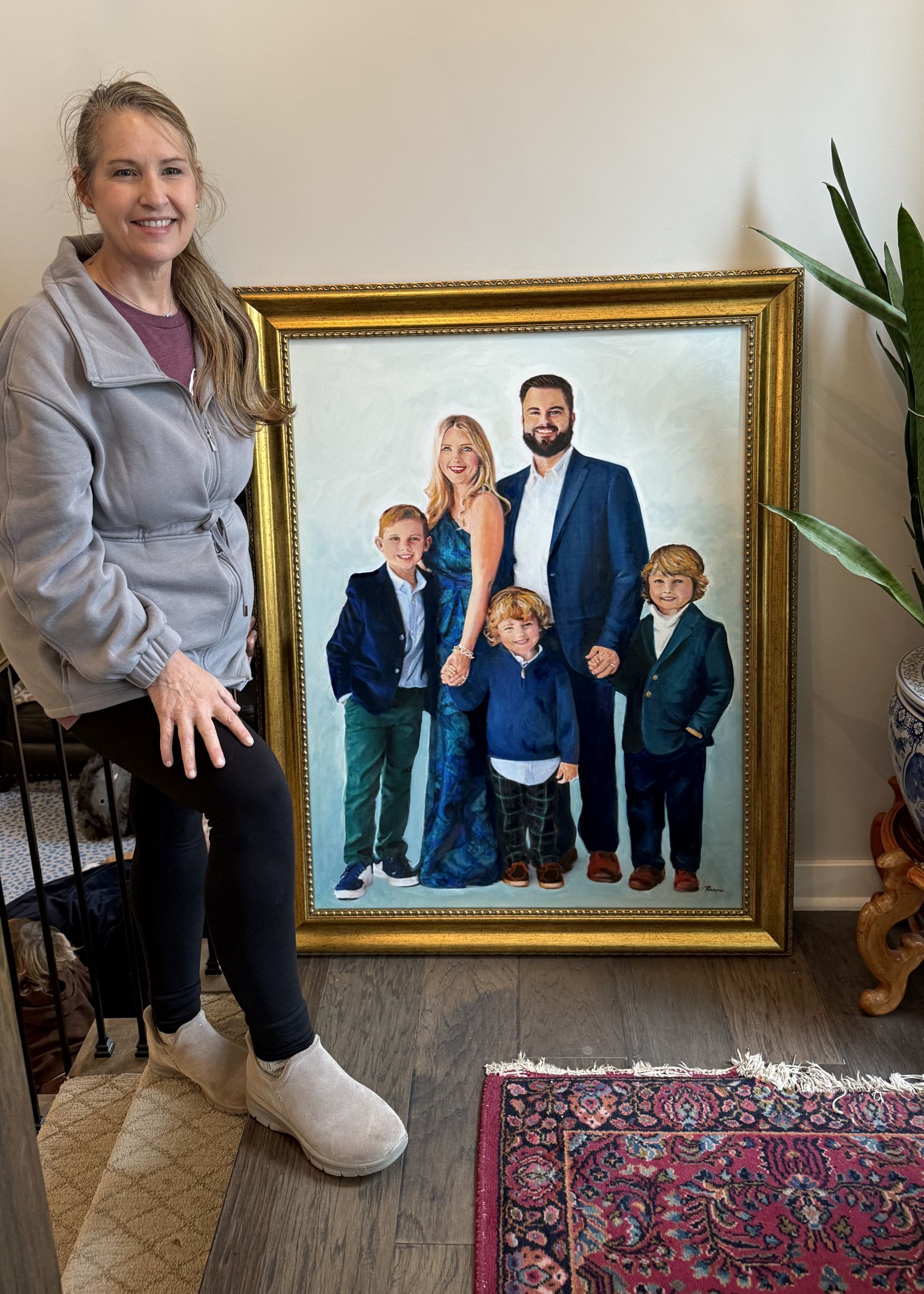 Rayne with a commissioned portrait of a family of five